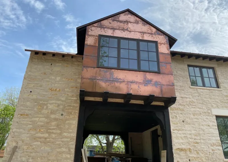 Copper metal panel facade on a stone building for Roof Repair in Sapulpa